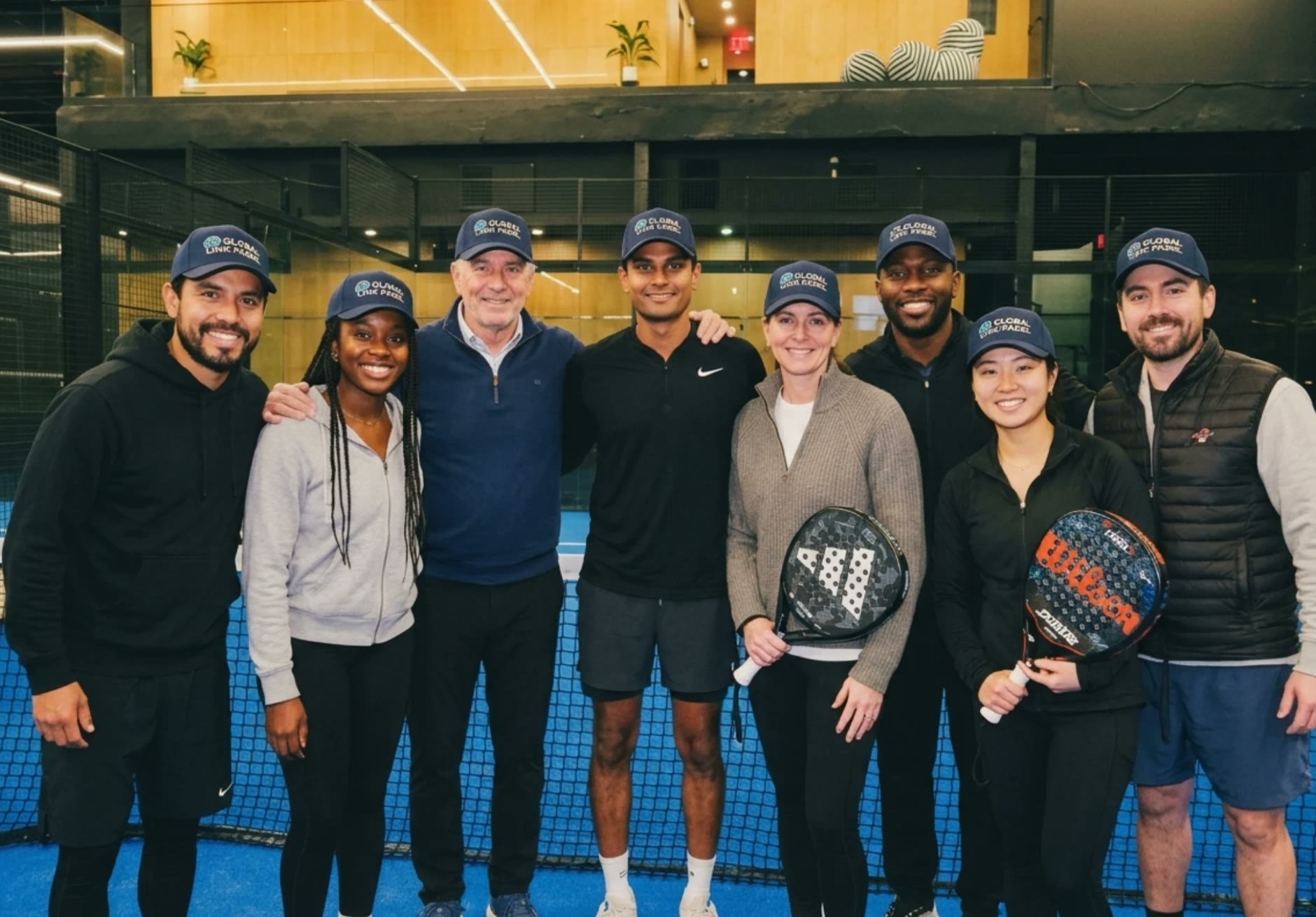 A company group posing on court after their event