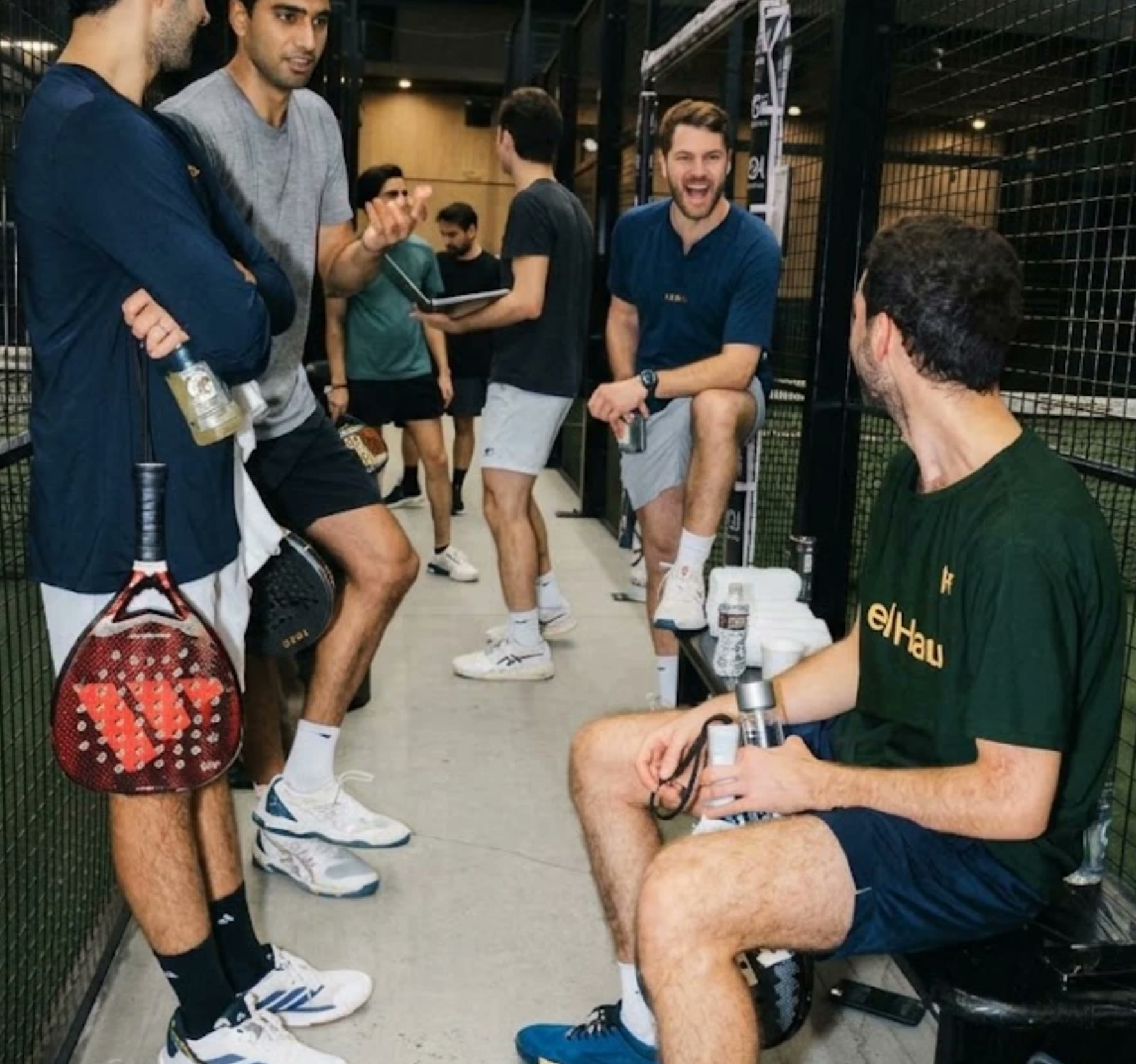 Players chatting between the courts at a padel club